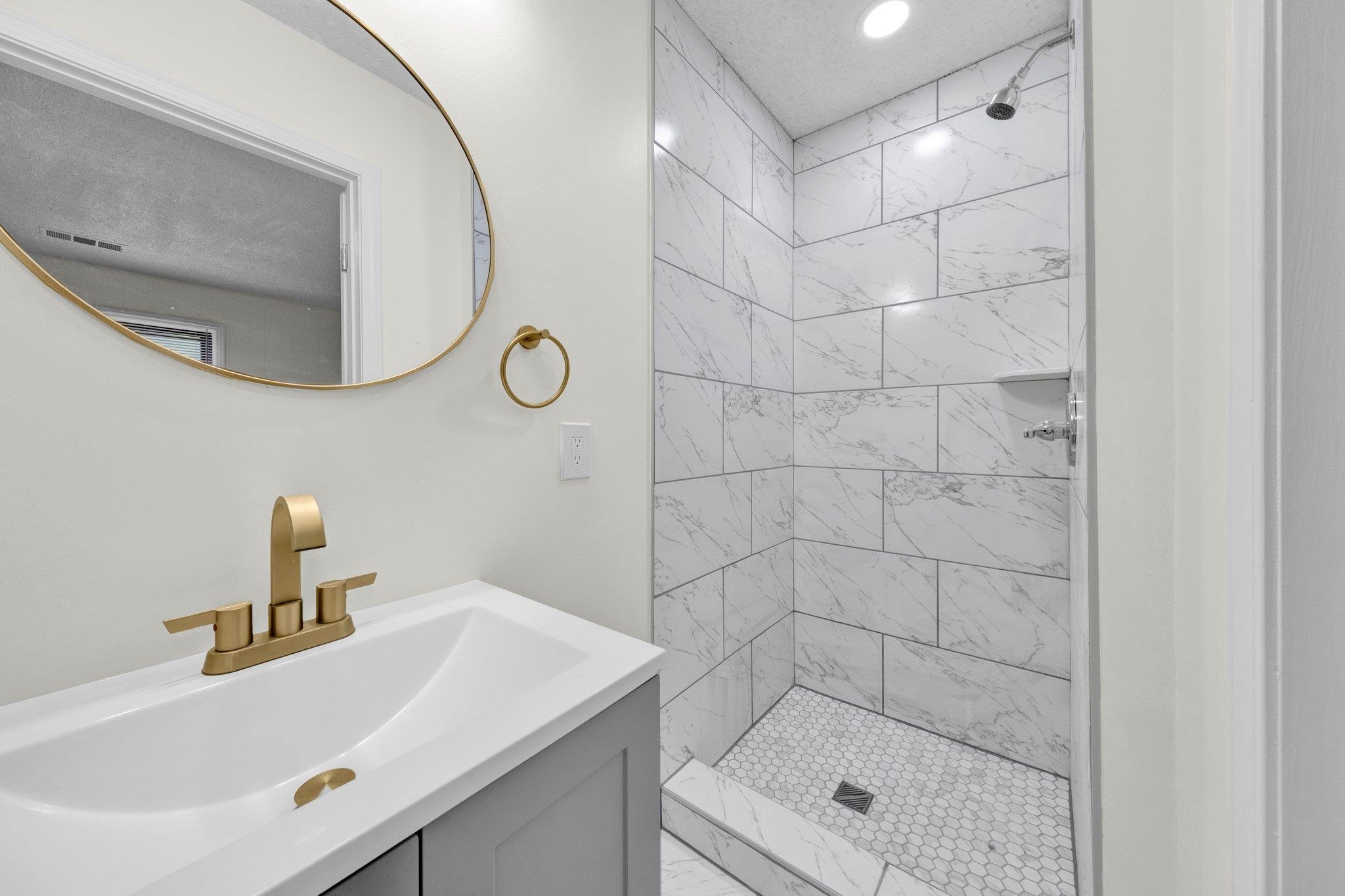 6681 Raleigh Millington Road Millington, TN 38053 - Photo 23 of 28 Bathroom featuring tiled shower and vanity