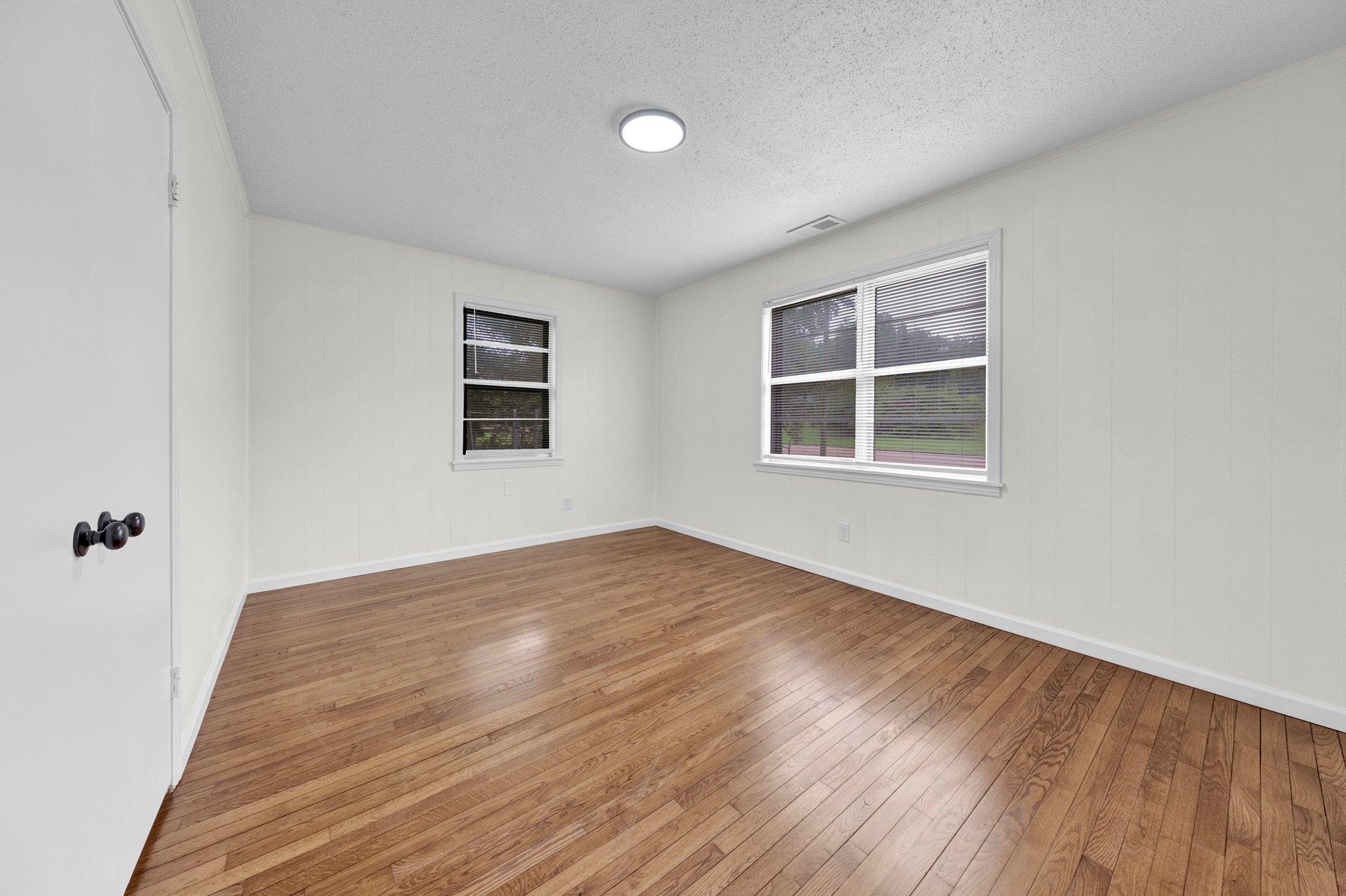 6681 Raleigh Millington Road Millington, TN 38053 - Photo 24 of 28 Unfurnished room featuring wood-type flooring and a textured ceiling