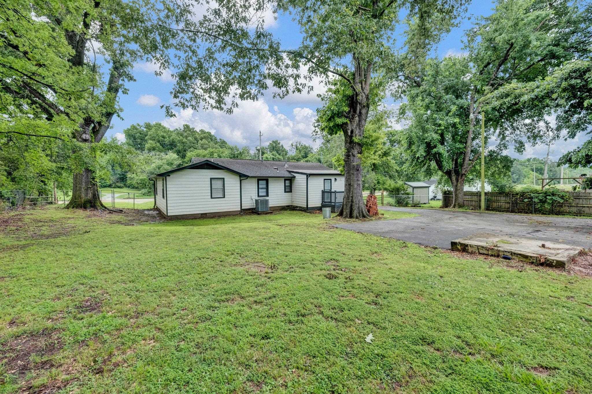6681 Raleigh Millington Road Millington, TN 38053 - Photo 27 of 28 Rear view of property with crawl space, asphalt driveway, and view of wooded area