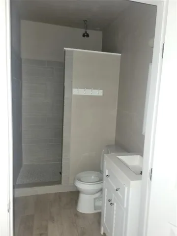 a white toilet sitting next to a bathroom sink