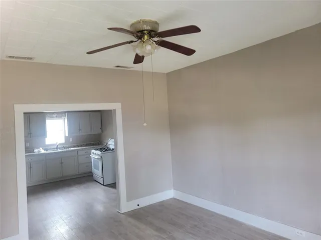 a view of a kitchen with a sink and a stove top oven