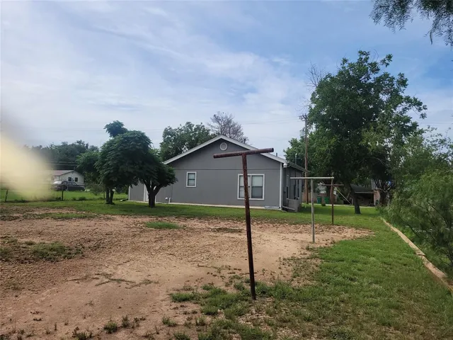a backyard of house with trees