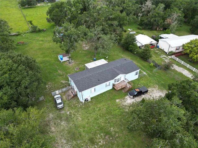 an aerial view of a house with a yard