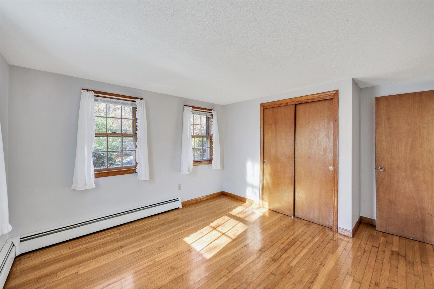 360 Airline Road South Dennis, MA 02660 - Photo 18 of 30 an empty room with wooden floor and windows