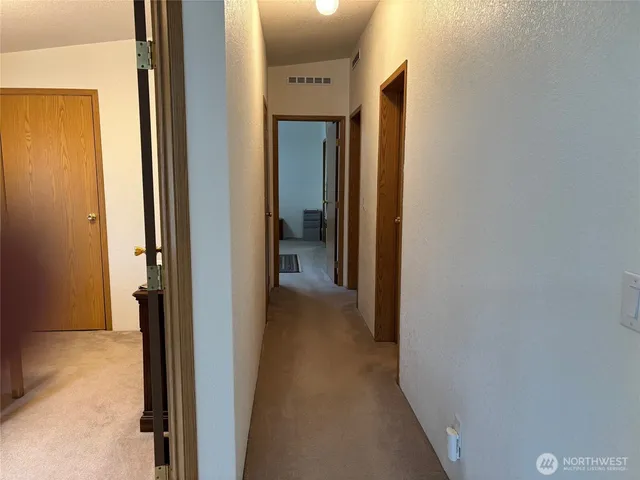 a view of a bathroom from a hallway