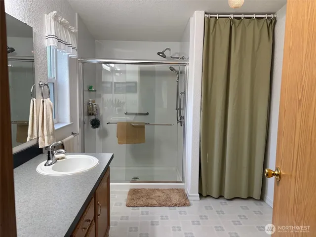 a bathroom with a shower and a sink