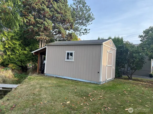 a backyard of a house with plants and tree
