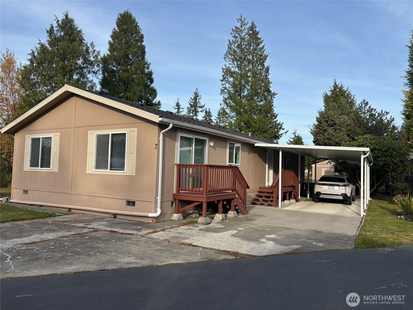 8370 Harborview Road, Unit 7 Blaine, WA 98230 - Photo 4 of 29 a view of a house with a yard and sitting area