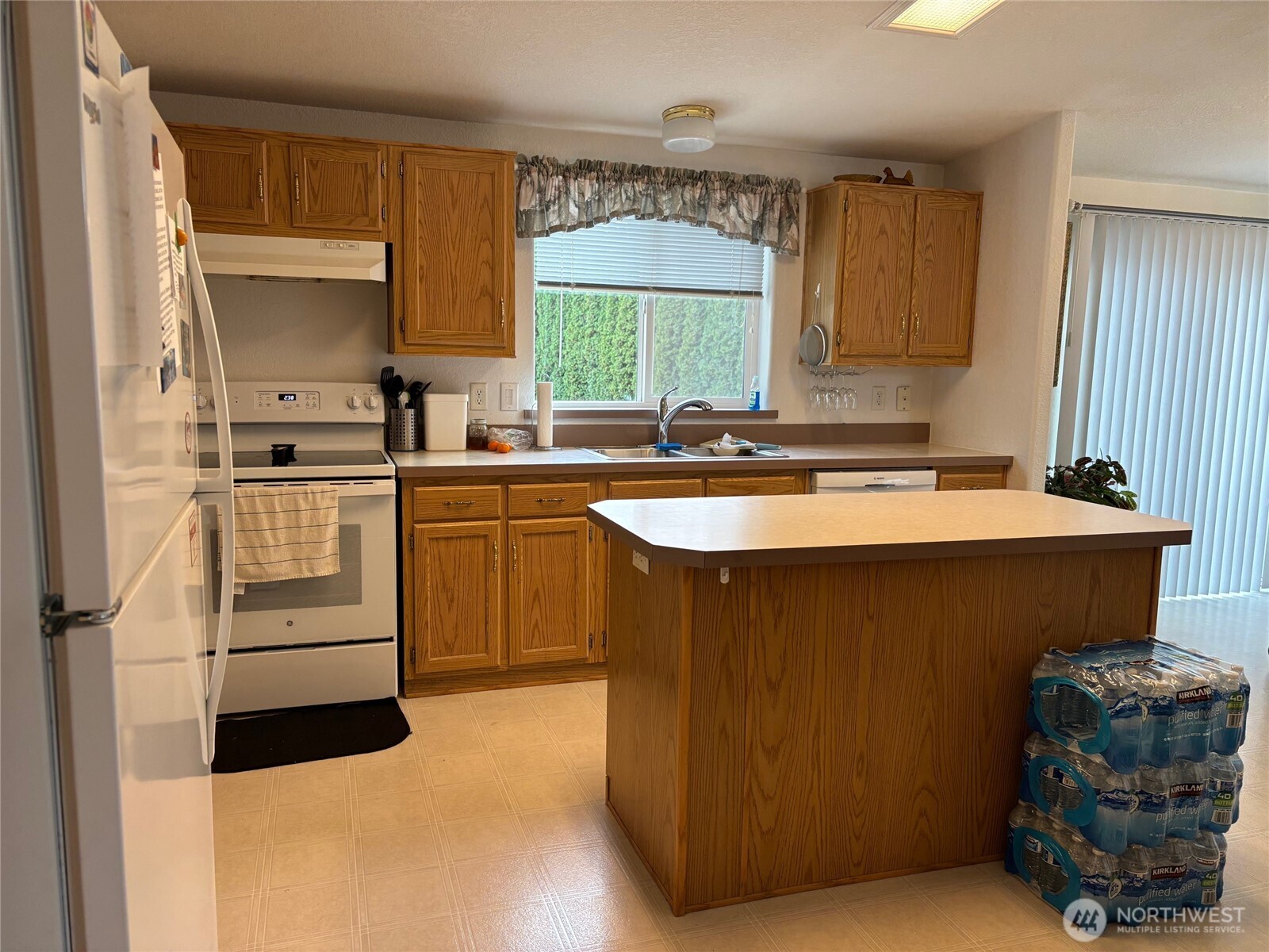 8370 Harborview Road, Unit 7 Blaine, WA 98230 - Photo 6 of 29 a kitchen with stainless steel appliances granite countertop a stove a sink and a refrigerator