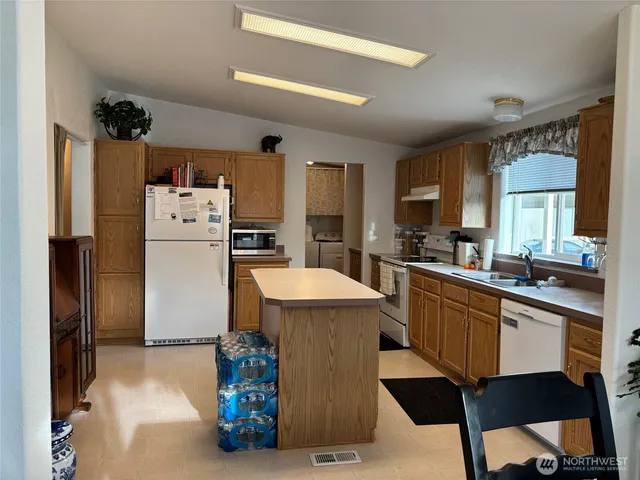 a kitchen with refrigerator and window