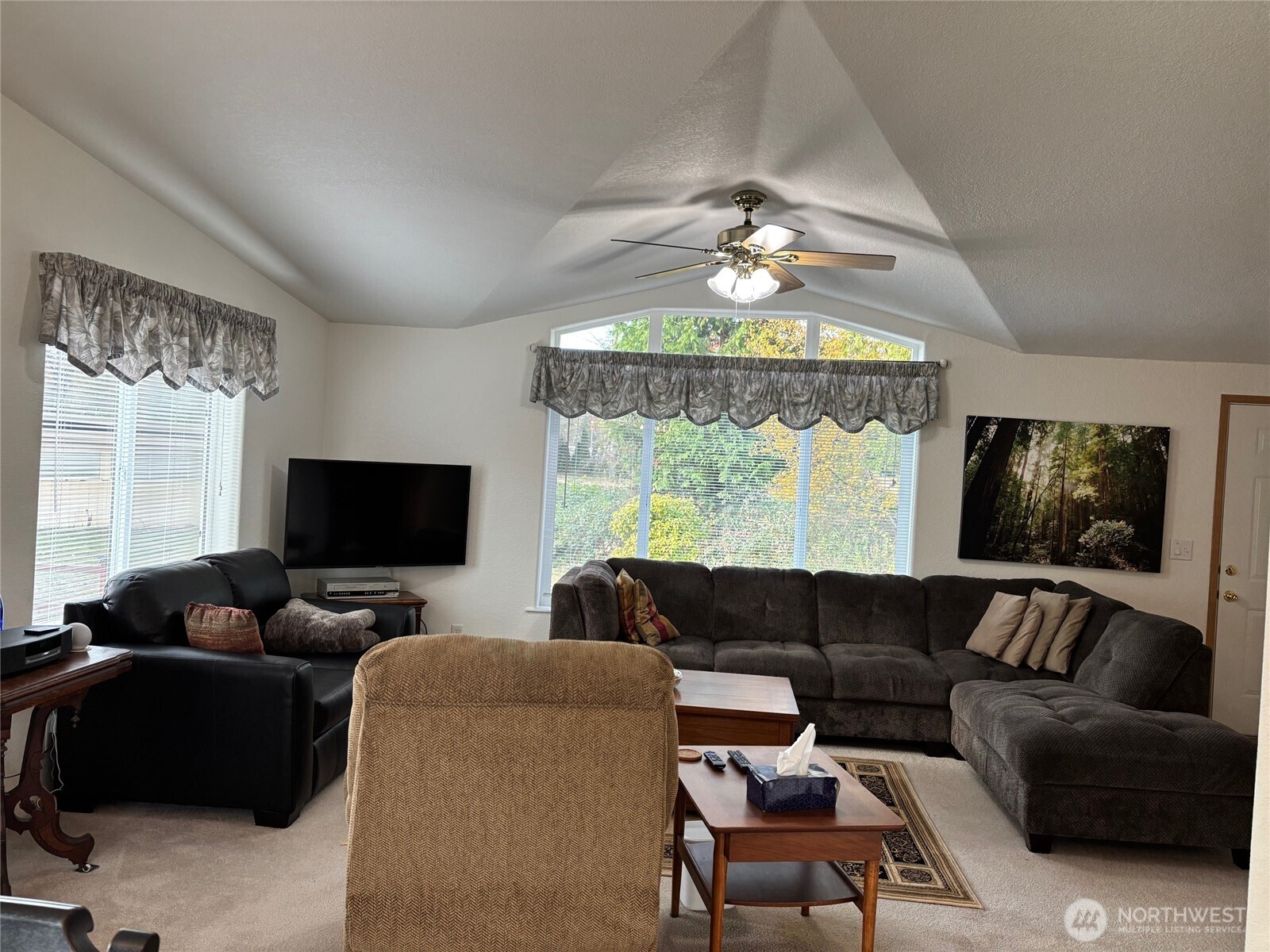 8370 Harborview Road, Unit 7 Blaine, WA 98230 - Photo 10 of 29 a living room with furniture a chandelier and a flat screen tv