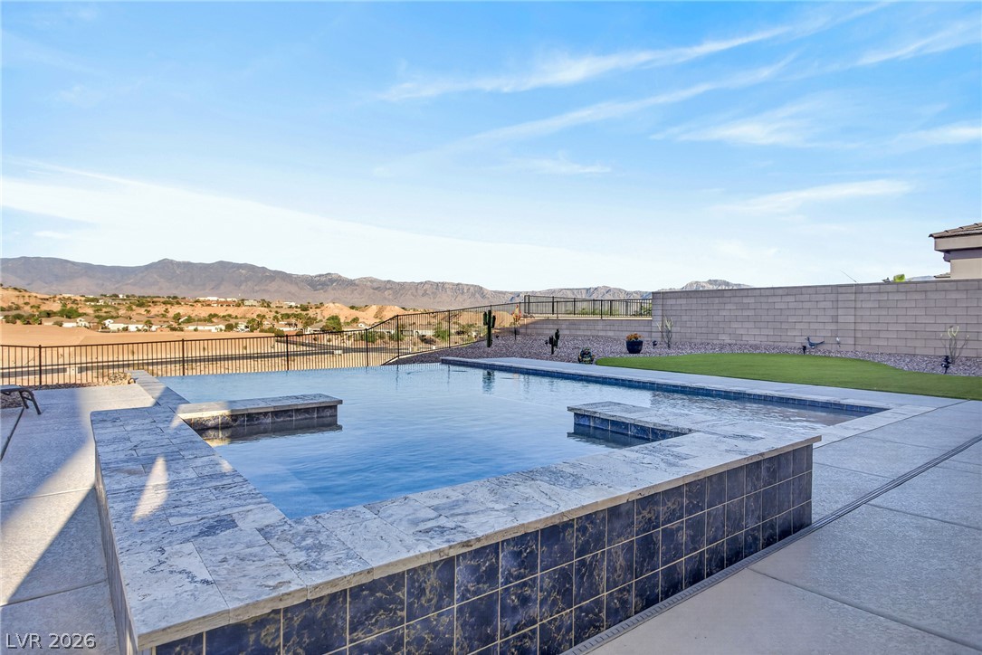 1460 Blue Ridge Trail Mesquite, NV 89027 - Photo 28 of 39 Infinity edge pool overlooking a captivating desert and mountain vista.