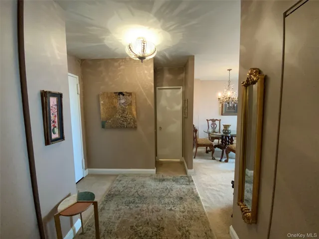 a view of a hallway with dining area and glass door