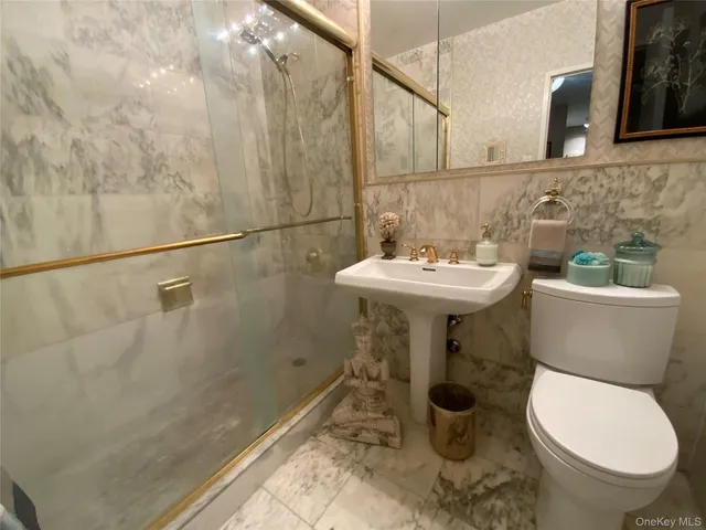 a bathroom with a sink toilet and a mirror