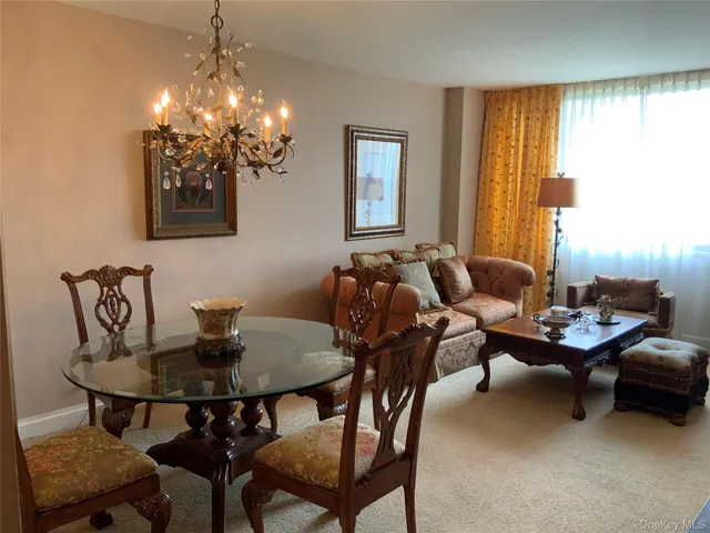 a view of a dining room with furniture and chandelier