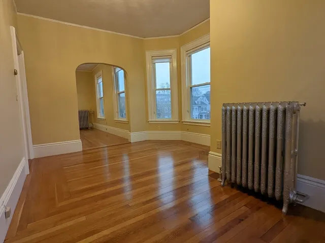 a view of a room with wooden floor and window