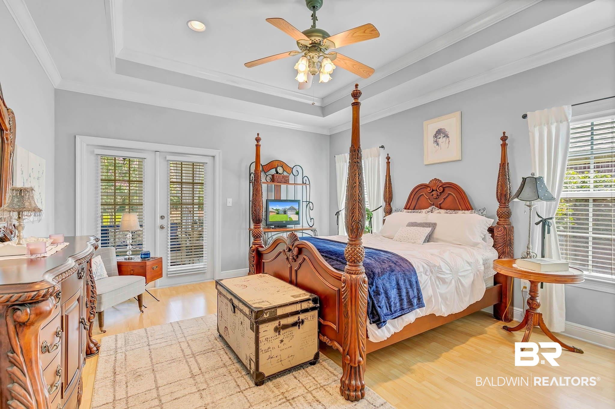 213 Hemingway Loop Foley, AL 36535 - Photo 26 of 69 Bedroom featuring access to exterior, light wood-style flooring, a raised ceiling, french doors, and a ceiling fan