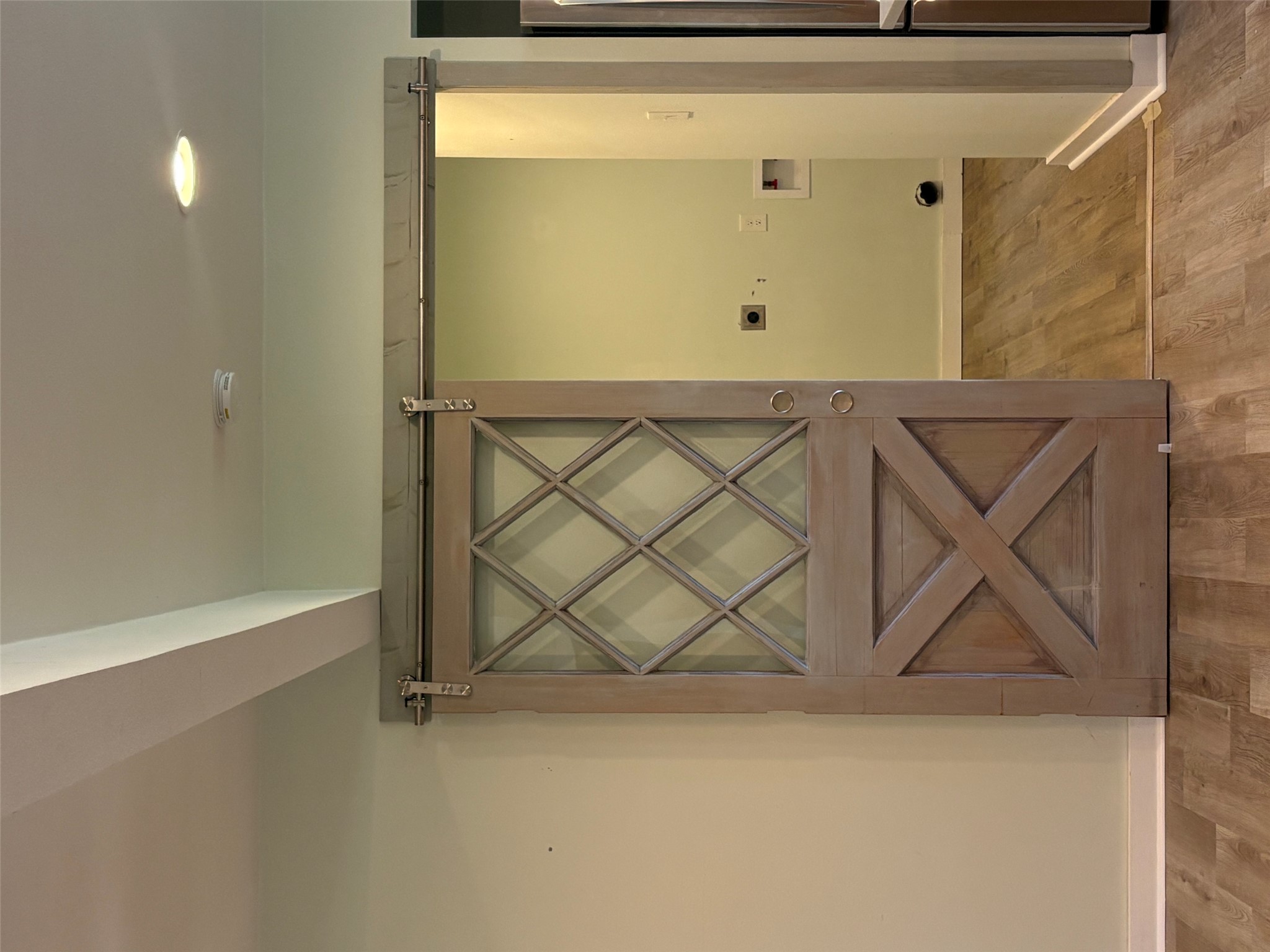 9032 Nuckols Crossing Road Austin, TX 78744 - Photo 6 of 14 A charming barn door with diamond-pane windows introduces a functional laundry area.