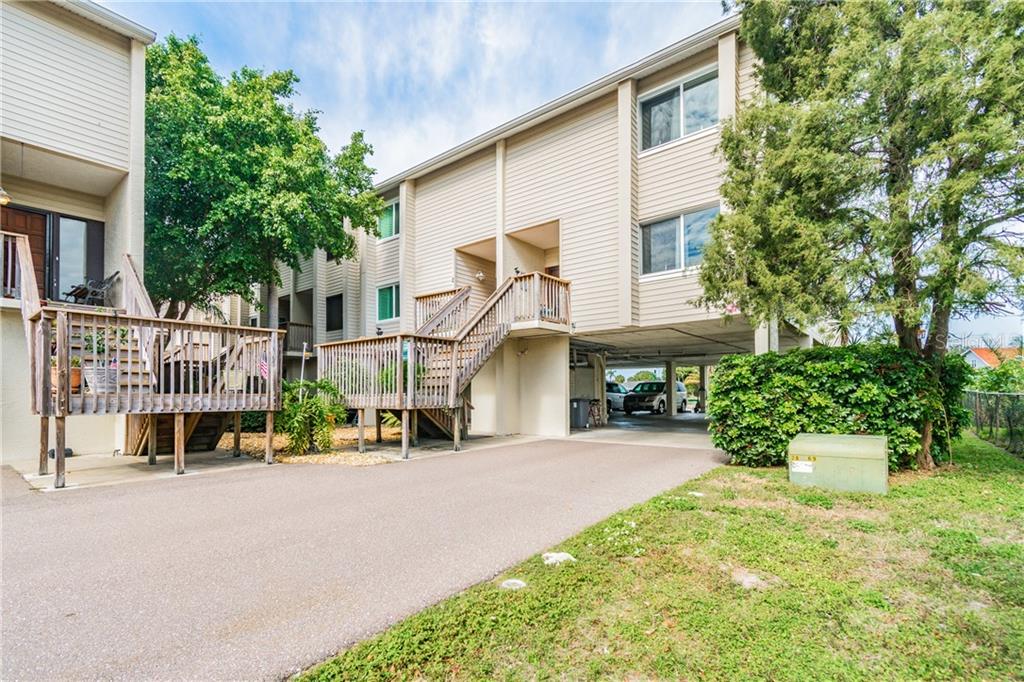 322 Windrush Boulevard, Unit 2 Indian Rocks Beach, FL 33785 - Photo 1 of 1 a city street lined with buildings and trees