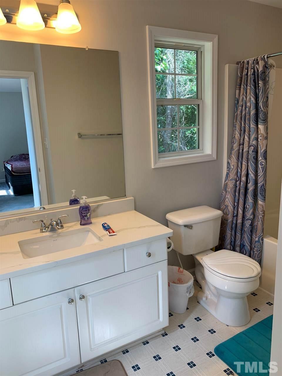 4920 Windproof Way Raleigh, NC 27616 - Photo 14 of 27 a bathroom with a sink toilet vanity and window