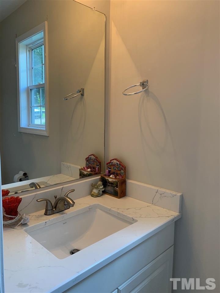 4920 Windproof Way Raleigh, NC 27616 - Photo 22 of 27 a bathroom with a sink and a washing machine