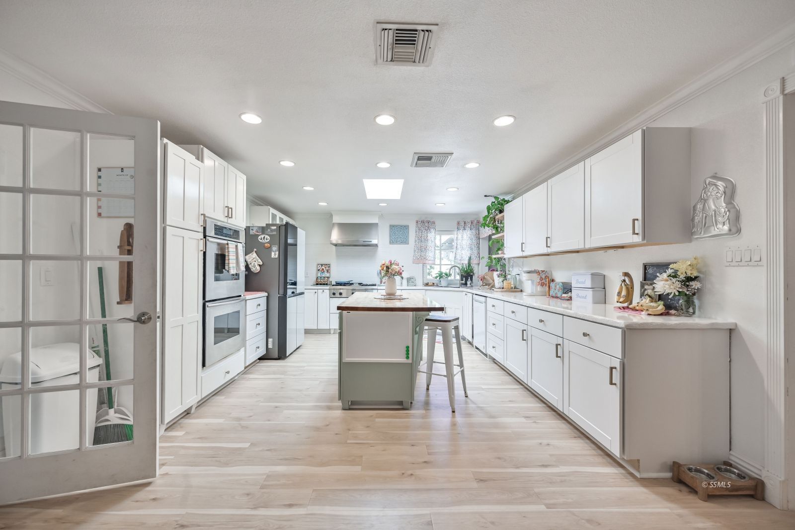 1025 Randall Street Ridgecrest, CA 93555 - Photo 4 of 50 a kitchen with white cabinets and stainless steel appliances