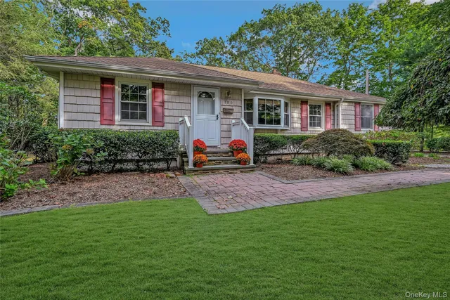 a front view of house with yard and green space