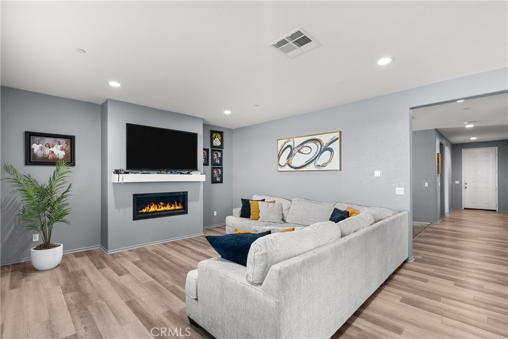 6949 Beale Road Palmdale, CA 93552 - Photo 4 of 32 a living room with furniture and a flat screen tv