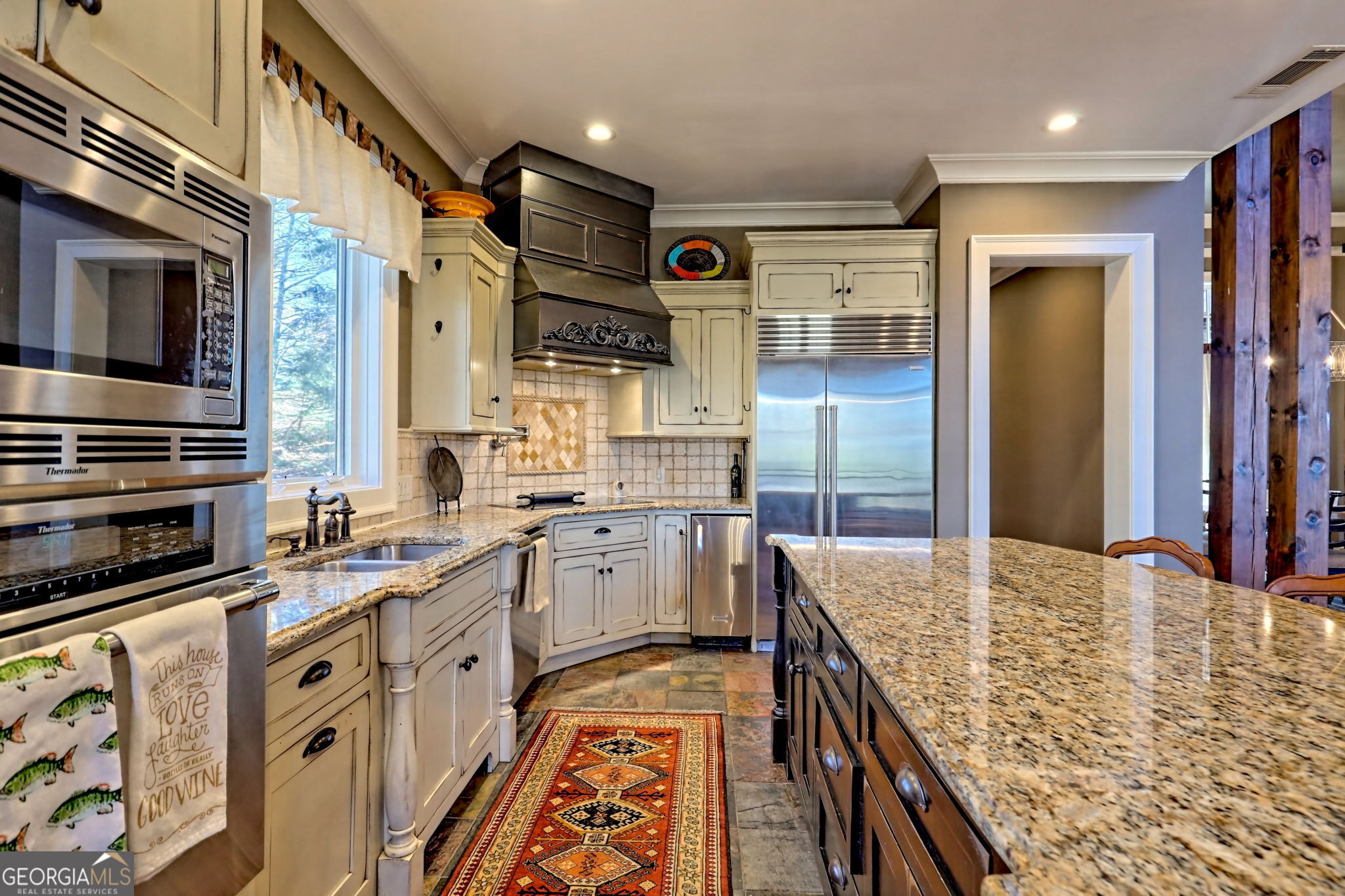 689 Waterfall Drive Clayton, GA 30525 - Photo 24 of 108 a kitchen with stainless steel appliances granite countertop a sink and cabinets