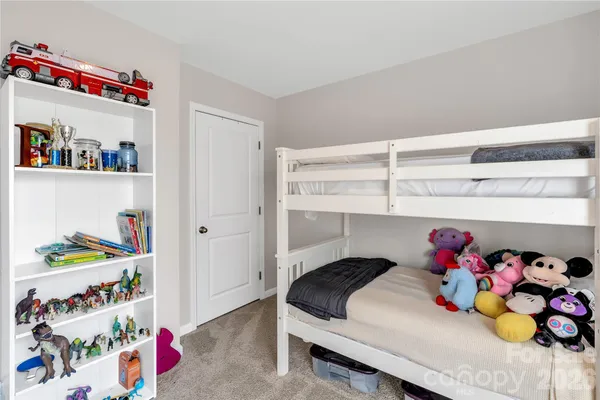a bedroom with a bed and a shelf