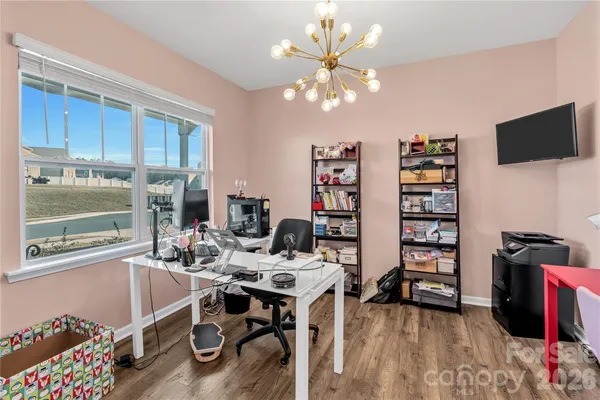 a view of a workspace with furniture and a window