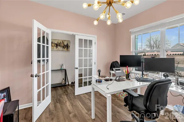 a view of a workspace with furniture and a window