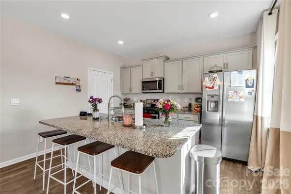 a kitchen with granite countertop lots of counter top space and refrigerator