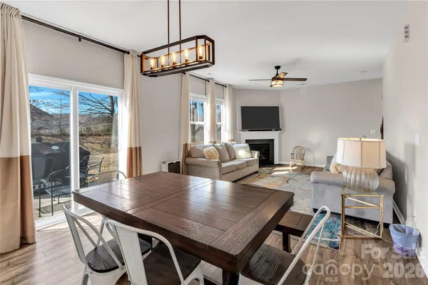 a view of a dining room with furniture wooden floor and chandelier