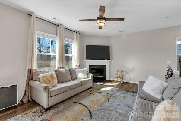 a living room with furniture flat screen tv and a fireplace