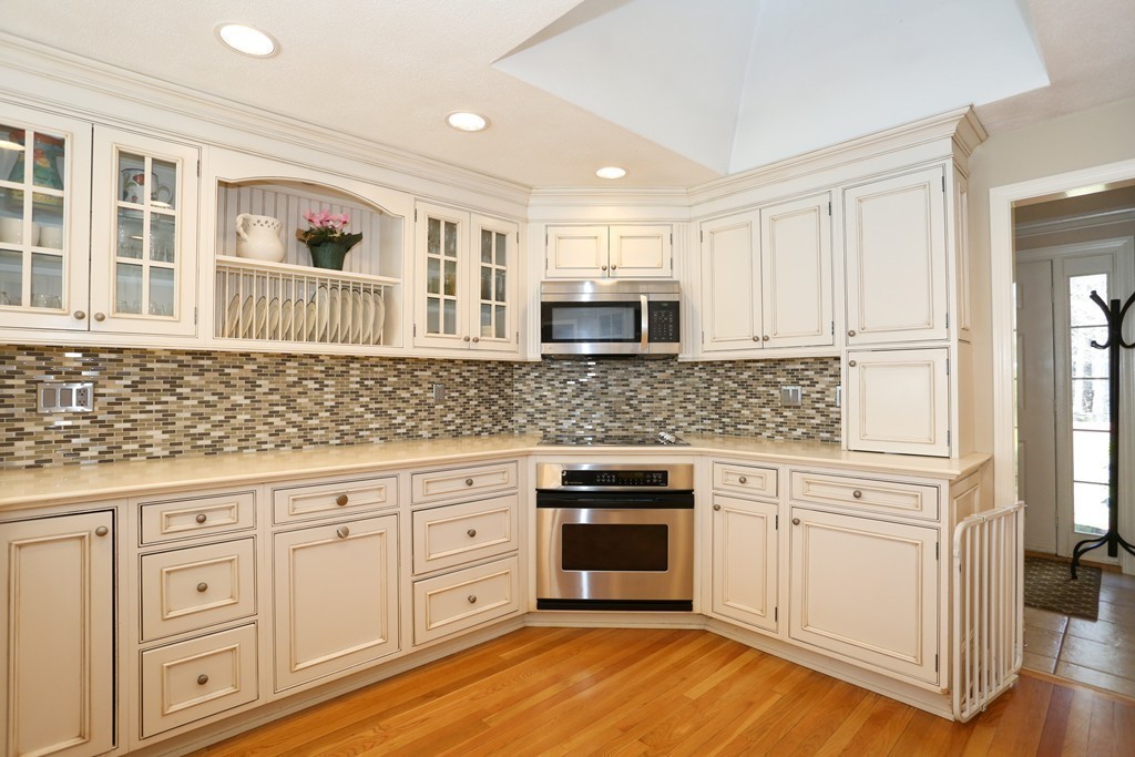 84 Fox Run Road Sudbury, MA 01776 - Photo 3 of 26 a kitchen with granite countertop white cabinets and stainless steel appliances