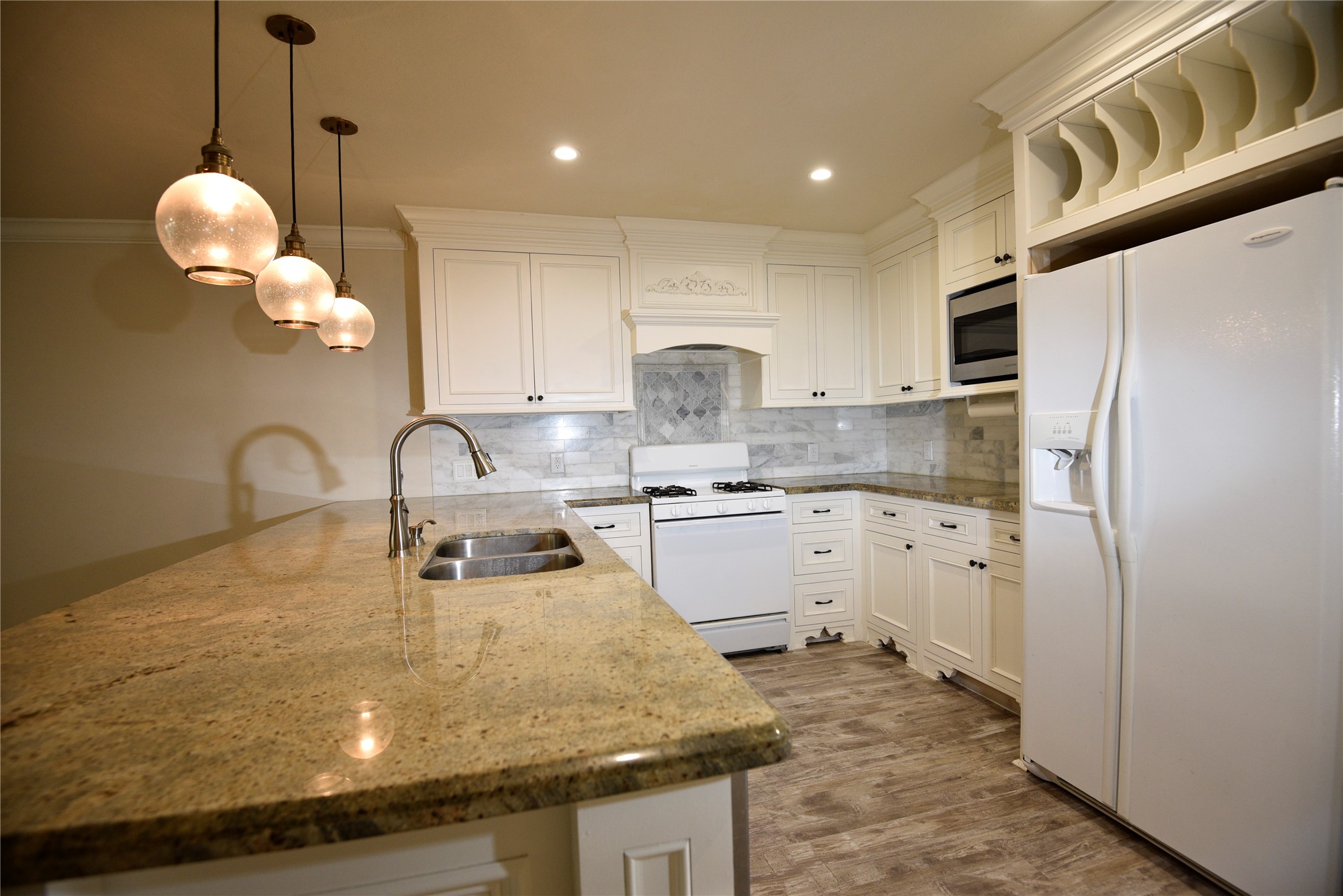 9997 Hyacinth Way Conroe, TX 77385 - Photo 8 of 45 a kitchen with stainless steel appliances granite countertop a sink a stove a refrigerator and cabinets