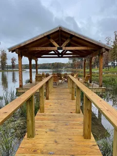 a view of a balcony with wooden floor and lake view