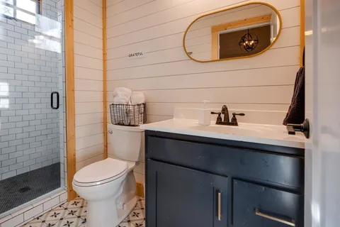 a bathroom with a sink toilet and shower