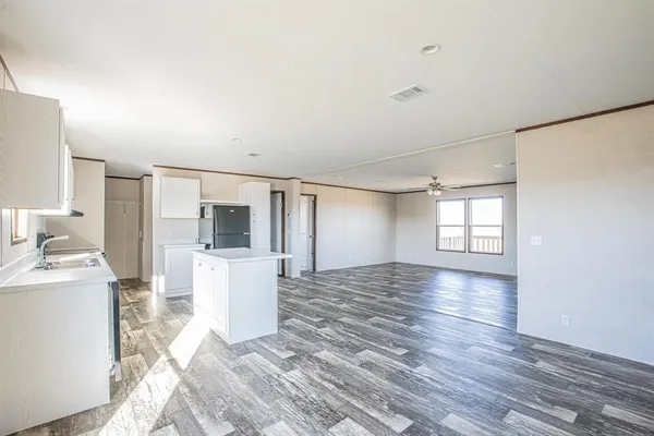 a view of empty room with wooden floor and window
