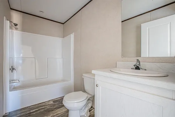 a bathroom with a sink toilet vanity and shower
