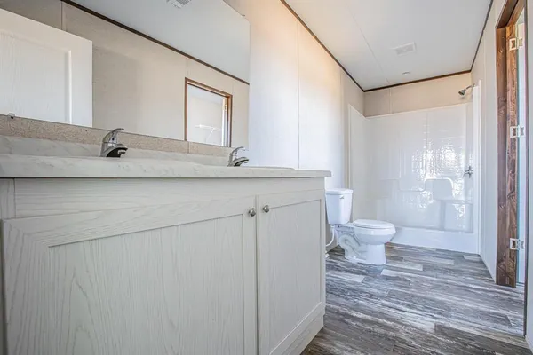 a bathroom with a toilet sink and shower