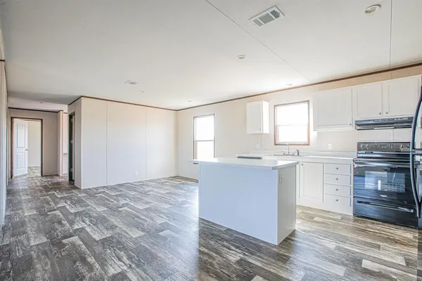 a room with a dresser and chandelier