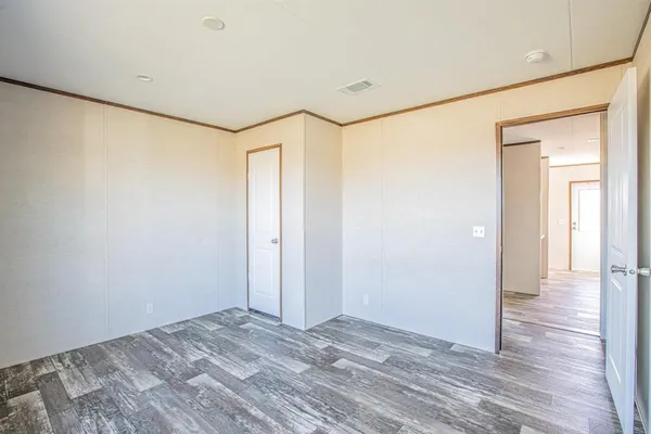 a view of a big room with wooden floor and a bathroom