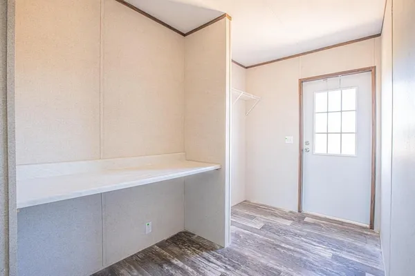 a view of an empty room with wooden floor