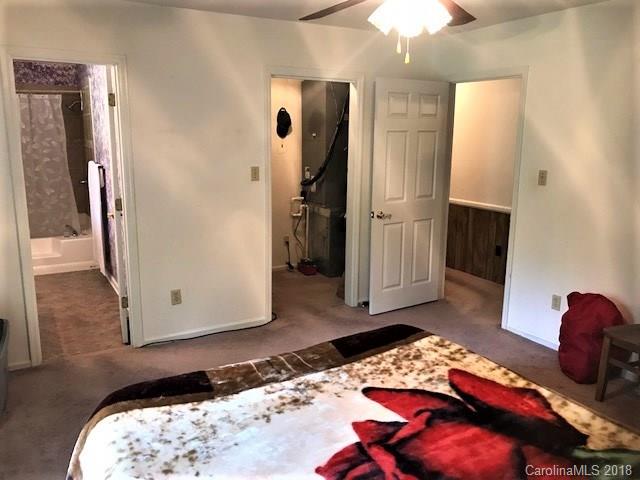 2426 New Cut Church Road Lancaster, SC 29720 - Photo 23 of 28 a bedroom with a bed and a chandelier