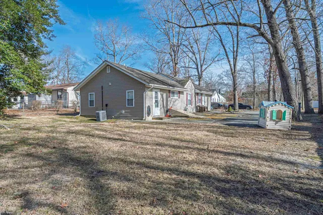 a view of a house with a yard covered with snow