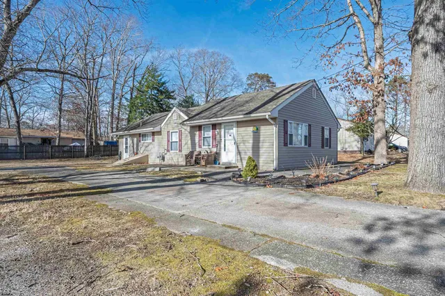 a view of a house with snow on the road