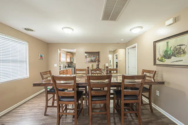 a view of a dining room with furniture and wooden floor