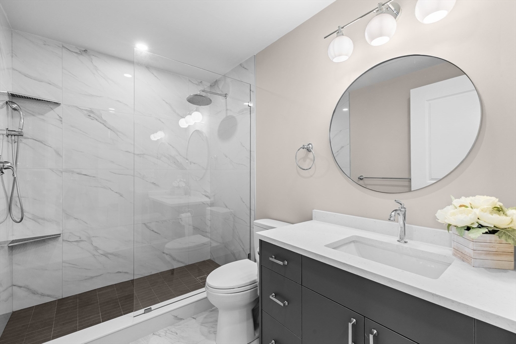 42 Waverly Street, Unit M Boston, MA 02135 - Photo 11 of 24 a bathroom with a sink a toilet and a mirror